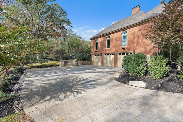 view of side of home featuring a garage