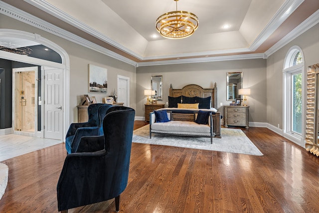 bedroom featuring hardwood / wood-style flooring, an inviting chandelier, a tray ceiling, crown molding, and access to outside