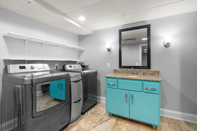 washroom with sink and independent washer and dryer