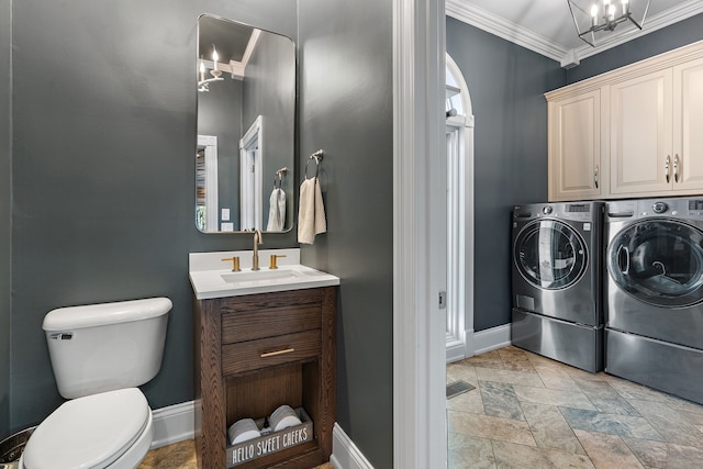 interior space with ornamental molding, vanity, toilet, and independent washer and dryer