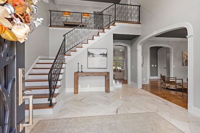 entryway featuring wood-type flooring and crown molding