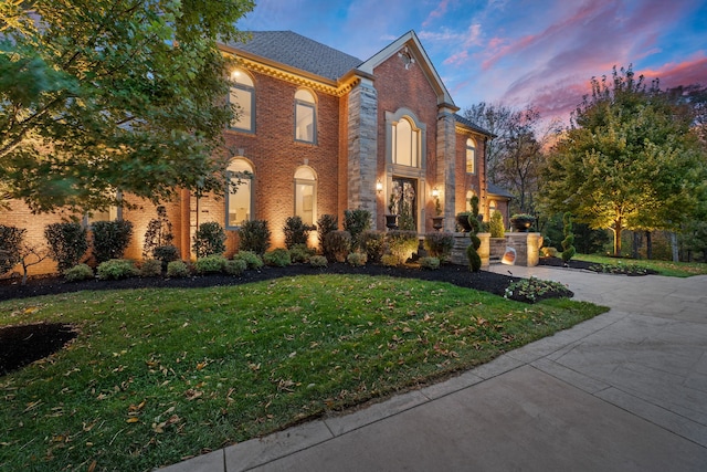 colonial inspired home with a lawn