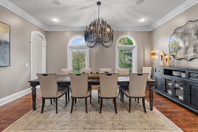 dining space with a wealth of natural light, wood-type flooring, and ornamental molding