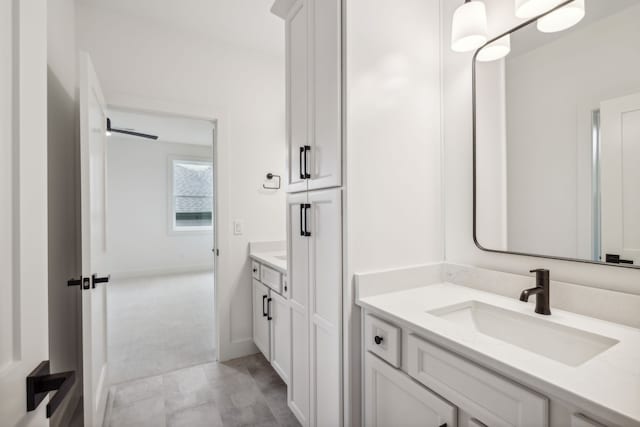 bathroom with vanity and baseboards