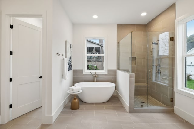 bathroom featuring tile patterned floors, plenty of natural light, and separate shower and tub