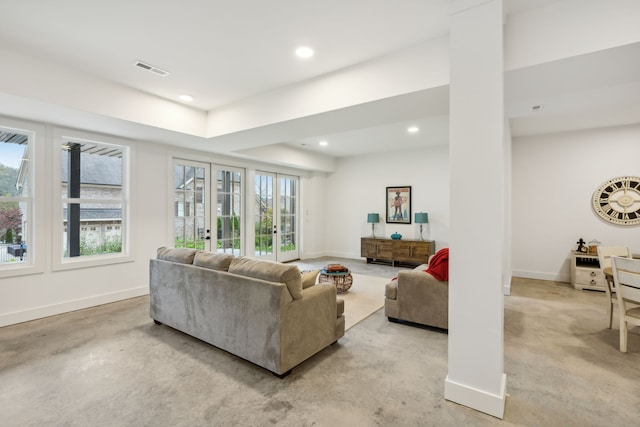 living room featuring plenty of natural light and french doors