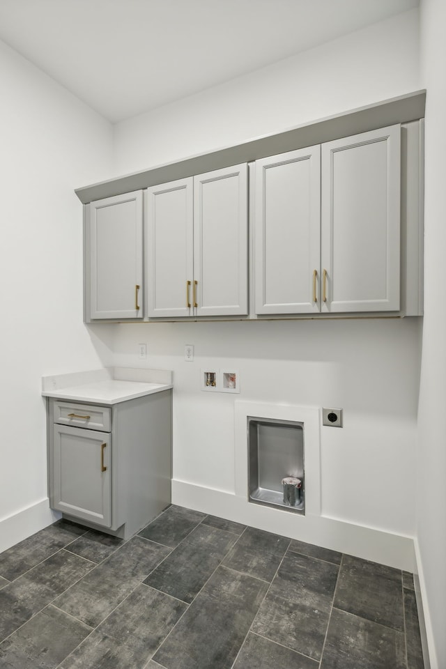 laundry area featuring hookup for an electric dryer, washer hookup, and cabinets