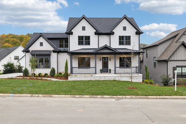 view of front facade with a front lawn and covered porch