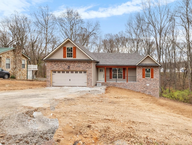 view of front of property featuring covered porch and a garage