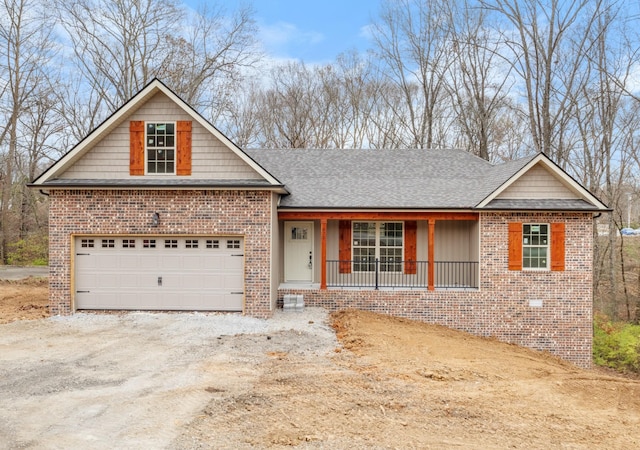 view of front facade featuring a porch and a garage