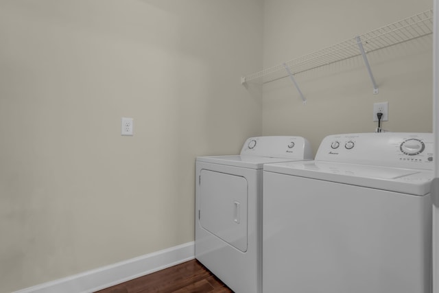 laundry room with dark hardwood / wood-style floors and washer and dryer