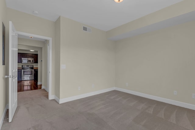 unfurnished room featuring light colored carpet