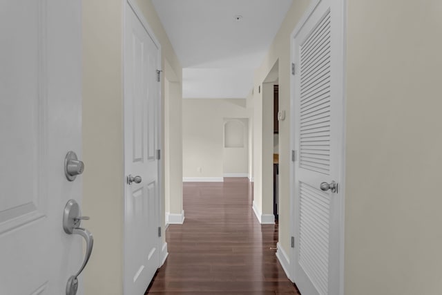 corridor with dark wood-type flooring