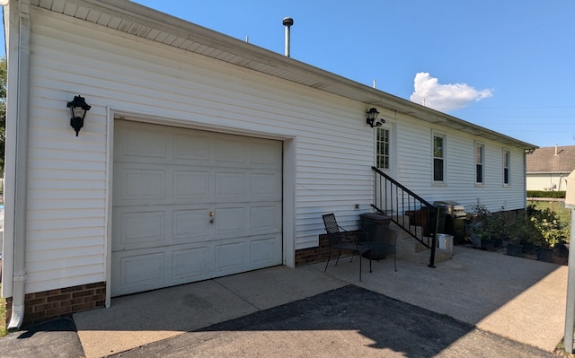 rear view of property with a garage