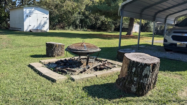 view of yard featuring a fire pit and a shed