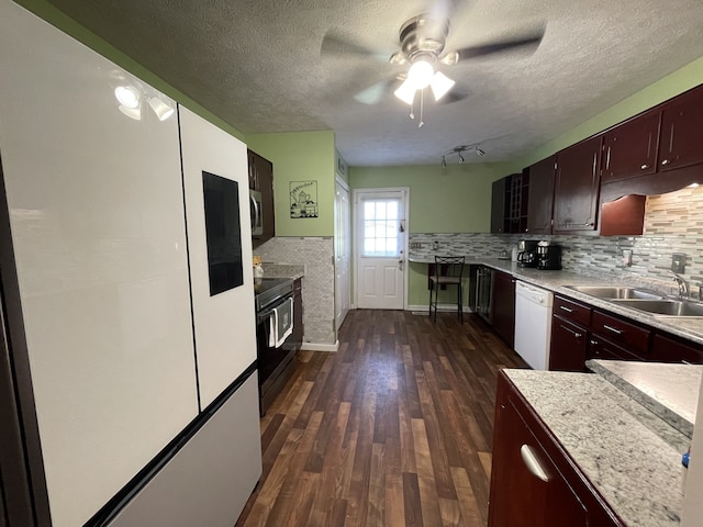 kitchen featuring a textured ceiling, dark hardwood / wood-style floors, sink, dishwasher, and black range with electric stovetop