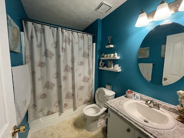 full bathroom featuring shower / bath combination with curtain, a textured ceiling, vanity, tile patterned floors, and toilet