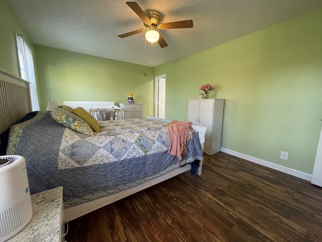 bedroom featuring dark hardwood / wood-style flooring and ceiling fan