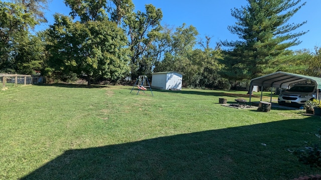 view of yard with a carport and a storage shed