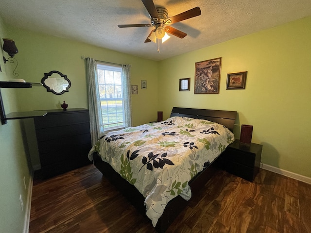 bedroom featuring a textured ceiling, ceiling fan, and dark hardwood / wood-style floors