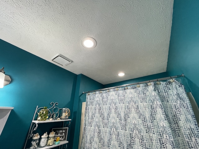 bathroom with a textured ceiling