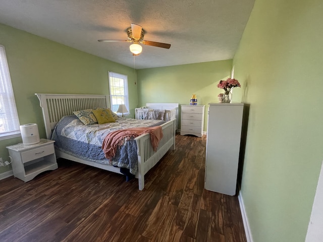 bedroom with a textured ceiling, dark hardwood / wood-style flooring, and ceiling fan