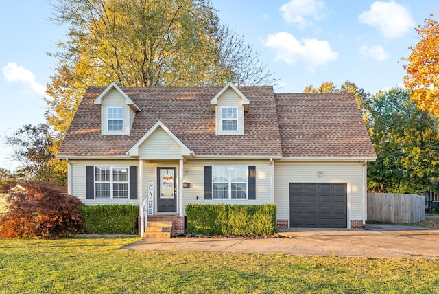 cape cod-style house featuring a front lawn and a garage