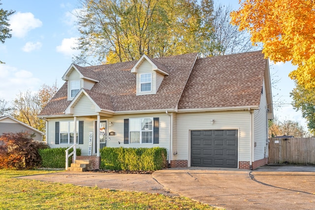 cape cod home featuring a garage