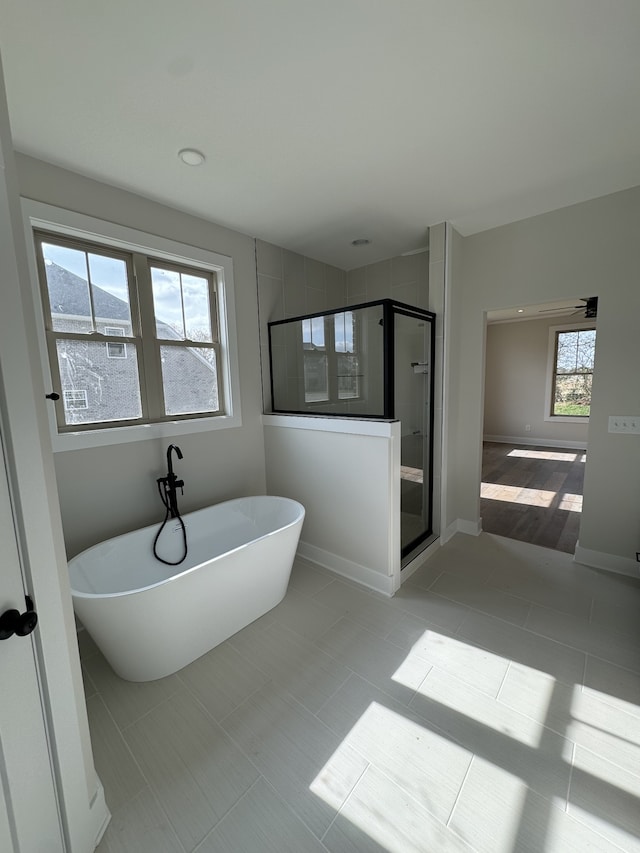 bathroom with tile patterned floors and independent shower and bath