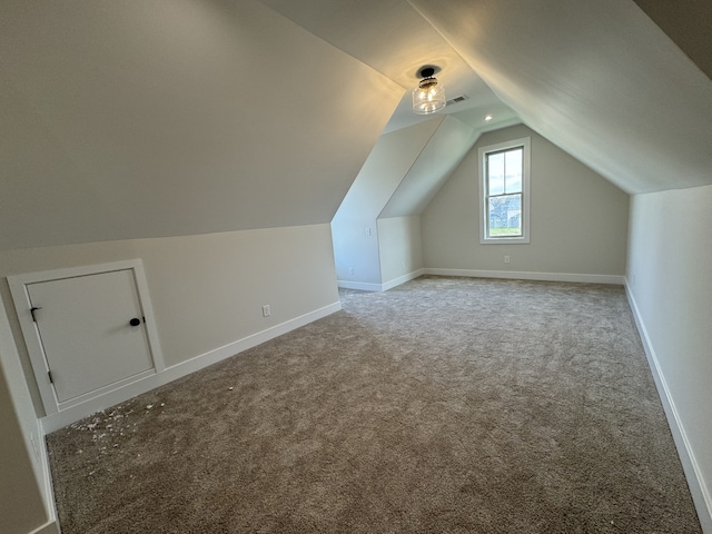 bonus room featuring carpet floors and vaulted ceiling