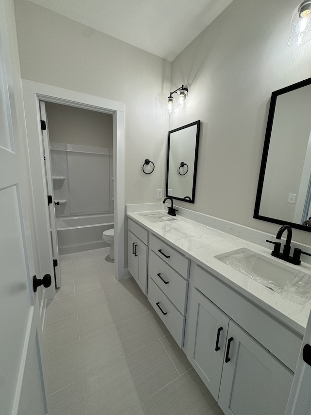 full bathroom with tile patterned flooring, vanity, toilet, and washtub / shower combination