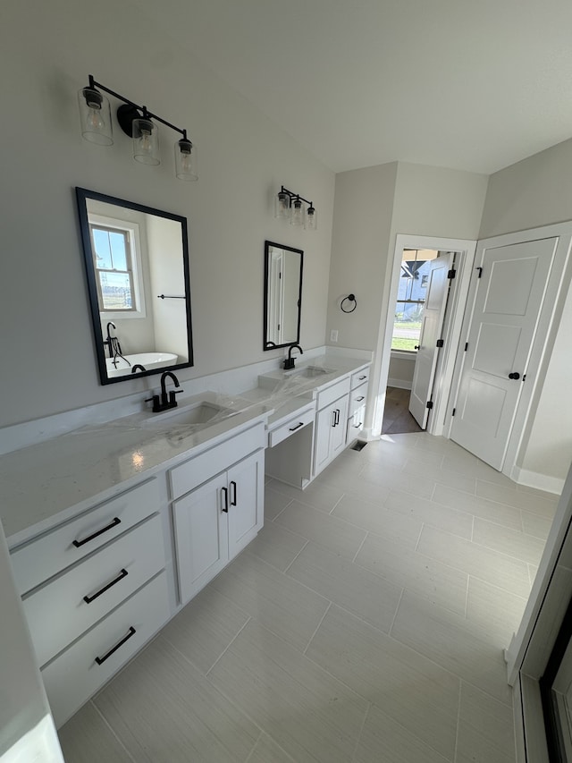 bathroom with tile patterned flooring, plenty of natural light, and vanity