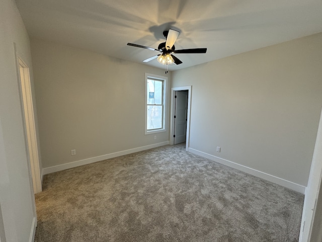 carpeted empty room with ceiling fan