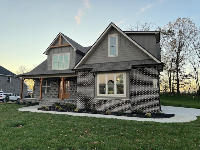 craftsman-style house with a lawn and a porch