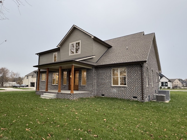 back of house with a porch, a yard, and cooling unit