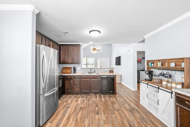 kitchen with dark brown cabinetry, ceiling fan, sink, black appliances, and dark hardwood / wood-style floors