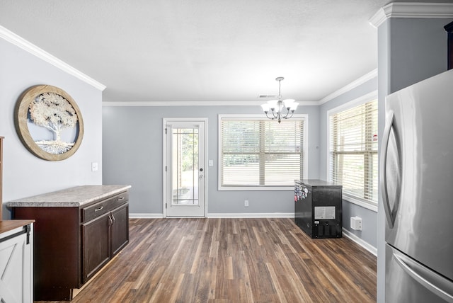 kitchen featuring an inviting chandelier, dark wood-type flooring, stainless steel refrigerator, and a healthy amount of sunlight