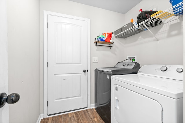 laundry room with separate washer and dryer and dark hardwood / wood-style floors