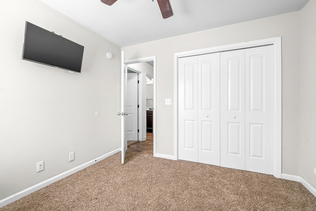 unfurnished bedroom featuring carpet flooring, a closet, and ceiling fan