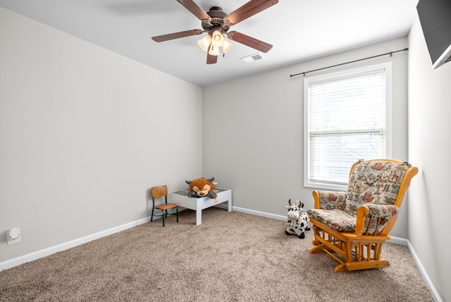 sitting room featuring carpet floors and ceiling fan