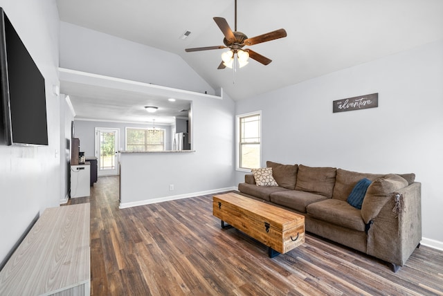 living room featuring dark hardwood / wood-style floors, vaulted ceiling, and ceiling fan