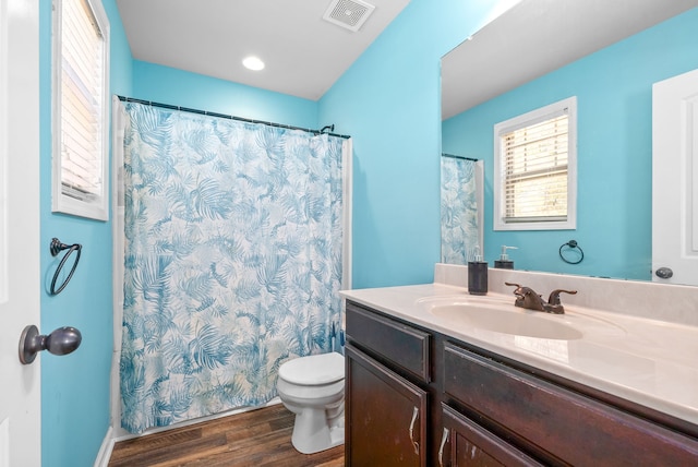 bathroom with hardwood / wood-style floors, vanity, and toilet