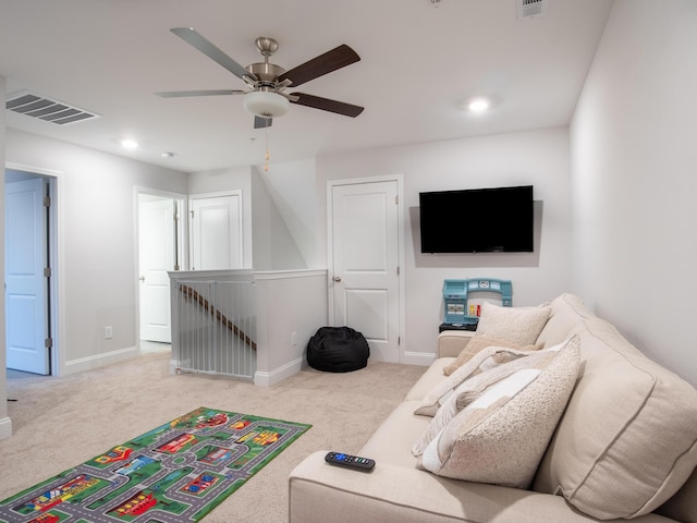 carpeted living room with ceiling fan