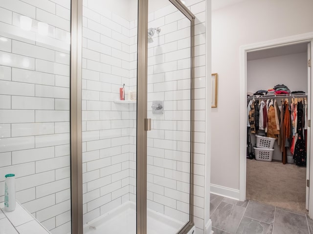 bathroom featuring a shower with shower door