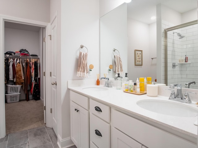 bathroom featuring tile patterned flooring, an enclosed shower, and vanity