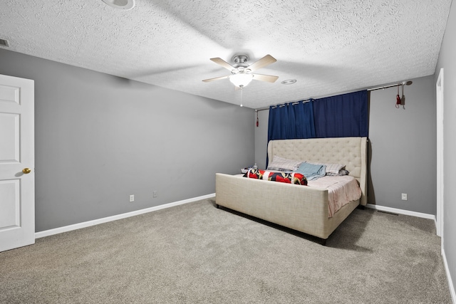 bedroom with carpet flooring, a textured ceiling, and ceiling fan