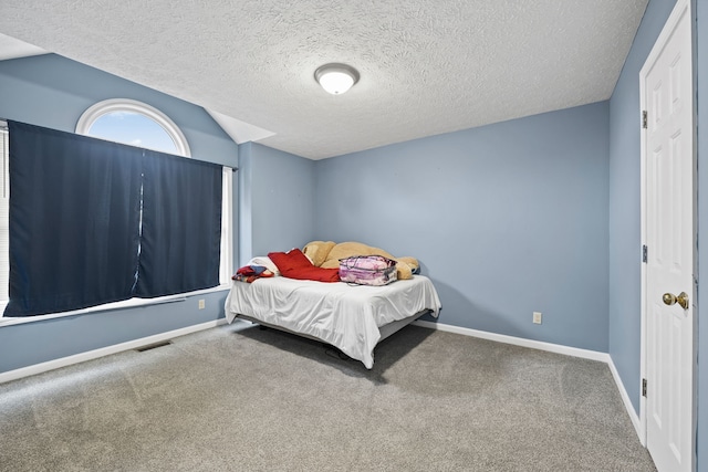 carpeted bedroom featuring a textured ceiling