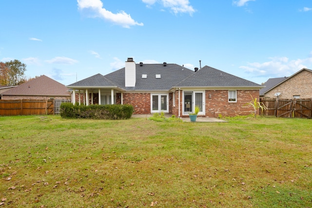 rear view of house with a lawn