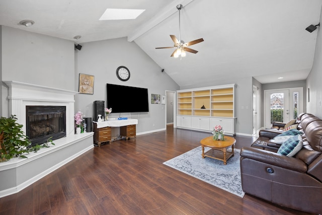 living room featuring ceiling fan, lofted ceiling with skylight, and dark wood-type flooring