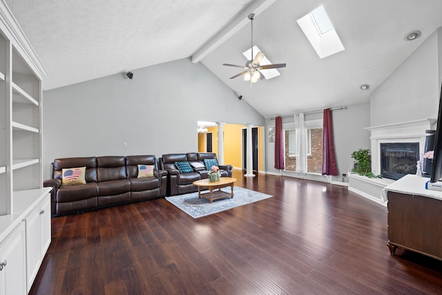 living room featuring lofted ceiling with beams, ceiling fan, dark hardwood / wood-style flooring, and a textured ceiling